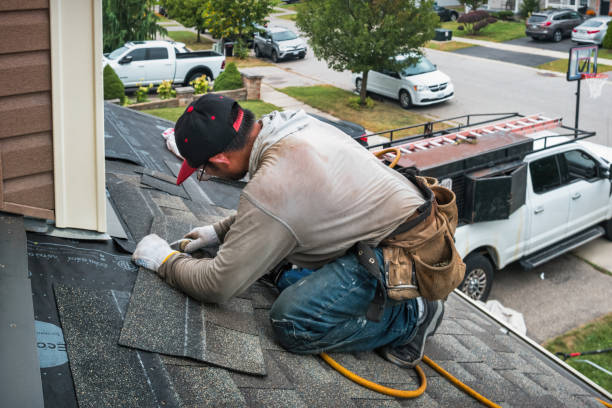 Professional Roofing technician working in Elwood, NY